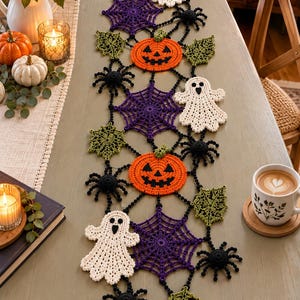 May include: A Halloween-themed crochet table runner featuring interconnected motifs of white ghosts, orange jack-o'-lanterns, purple spiderwebs, green leaves, and black spiders. The intricate yarn work creates a decorative seasonal display.