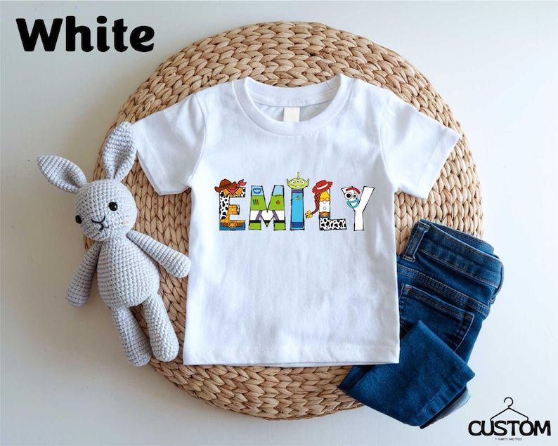 a white t - shirt with the word family on it next to a stuffed animal