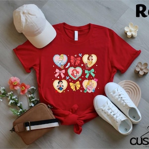 a red t - shirt with hearts and bows on it