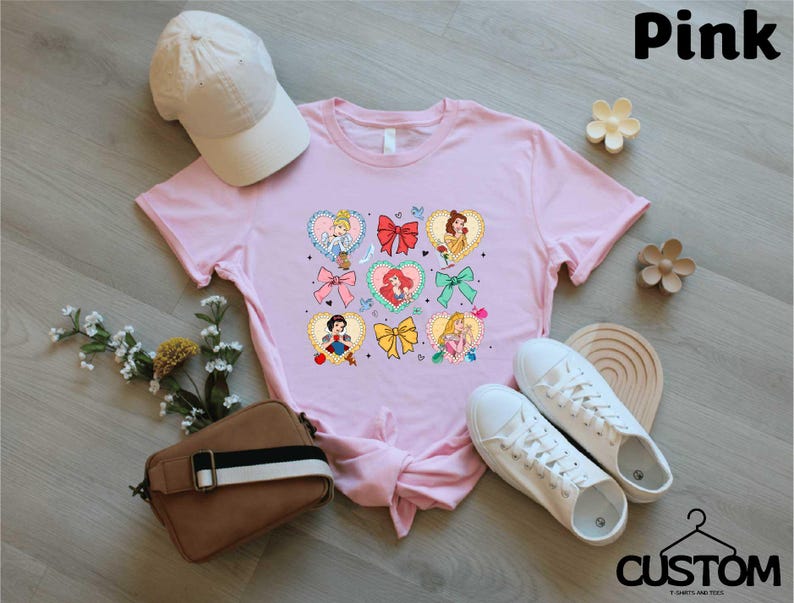 a pink shirt with a bunch of cartoon characters on it