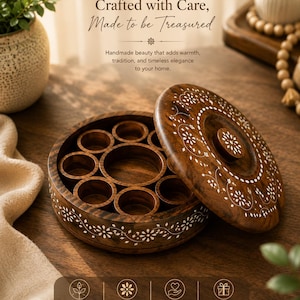 May include: A round, wooden spice box with a lid, featuring intricate white floral inlay designs. The box is open, revealing multiple compartments. The text "Crafted with Care, Made to be Treasured" is visible.