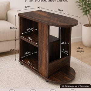 May include: A dark brown wood-grain side table with two open shelves and a curved top surface. The table features printed dimensions in centimetres, including a total height of 49cm, a width of 55cm, and a depth of 30cm, with various internal shelf measurements.