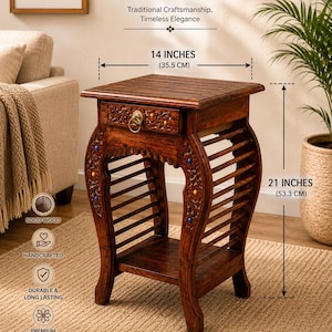 May include: A dark brown wooden side table with a single drawer featuring a brass ring pull, carved floral details with blue and yellow accents, and slatted sides. It measures 35.5 cm wide and 53.3 cm high, with a square top and lower shelf.