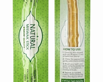 May include: A package of natural Miswak sticks, a traditional toothbrush alternative. The green packaging features text in multiple languages, including "Natural Miswak Stick" and instructions for use. The stick itself is visible through the clear packaging.