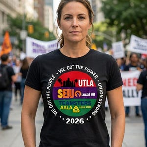 May include: Black t-shirt with a circular graphic featuring the text "WE GOT THE POWER" and union logos. The graphic includes "UTLA," "SEIU Local 99," and "TEAMSTERS AALA Local 2010." The year "2026" is also displayed. A woman is wearing the shirt.