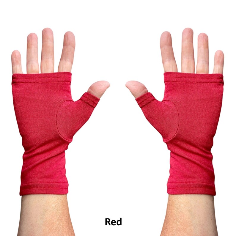 May include: A pair of fingerless gloves in a solid red color. The gloves feature an open-finger design that exposes the fingers while covering the palm and wrist area. The fabric appears to be a soft, smooth knit material with stitched hems.