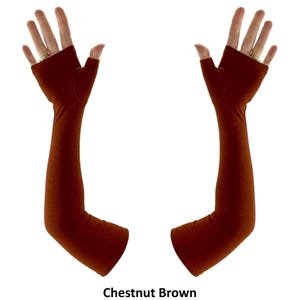 May include: A pair of chestnut brown fingerless arm sleeves that extend from the knuckles to the mid-forearm. The sleeves are made of a solid, smooth fabric and feature an opening for the thumb, leaving the fingers exposed. Text reads Chestnut Brown.