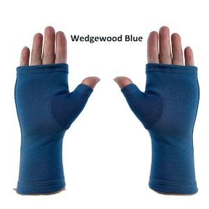 May include: A pair of fingerless gloves in a solid Wedgewood Blue color. The gloves feature a thumb hole and a straight-cut opening at the fingers, with visible stitching along the wrist and finger edges. The text Wedgewood Blue is displayed.