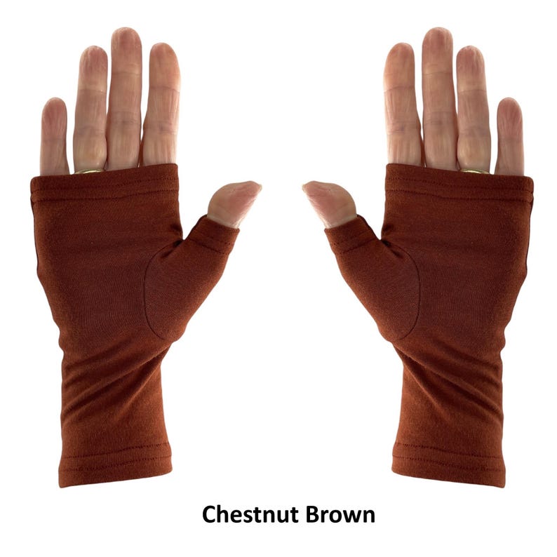 May include: A pair of fingerless gloves in a solid chestnut brown color. These gloves feature a thumb hole and cover the palm and wrist area, leaving the fingers exposed. The fabric has a smooth texture with visible stitching at the wrist and top.