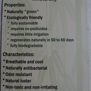 May include: A rectangular light green informational tag with dark green text titled Bamboo... naturally. It lists properties including fully sustainable, requires no pesticides, and fully biodegradable, plus characteristics like breathable, cool, and machine washable.