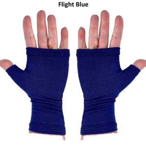 May include: A pair of fingerless gloves in a solid dark blue color labeled Flight Blue. These gloves feature a thumb hole and extend to cover the palm and wrist area, with visible stitched hem detailing at the top and bottom edges of the fabric.