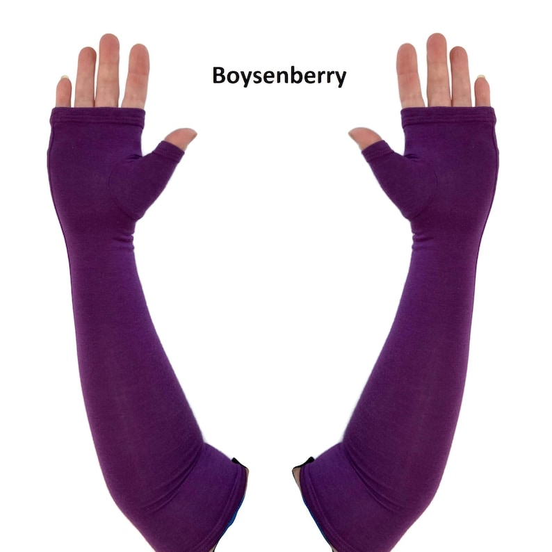 May include: A pair of fingerless arm warmers in a solid boysenberry purple colour. These long, sleeve-like gloves extend from the knuckles to the upper forearm, featuring a dedicated opening for the thumb and an open design for the fingers.