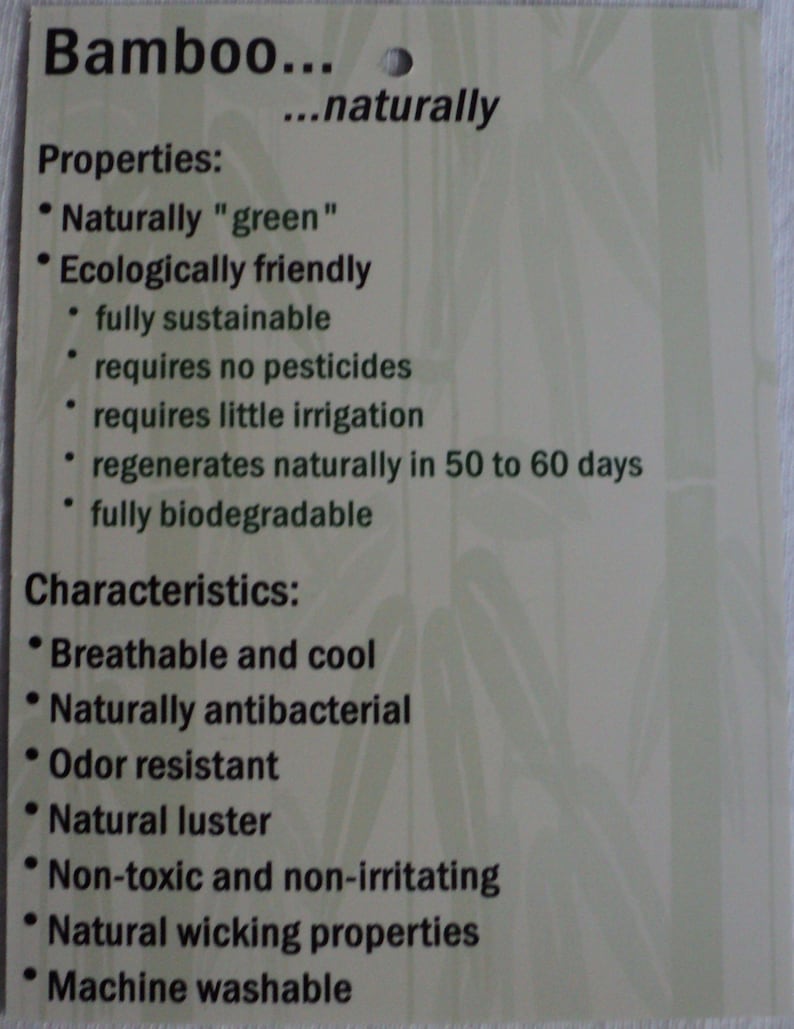 May include: A rectangular off-white product tag with dark green text detailing bamboo properties and characteristics. The text lists features including naturally green, ecologically friendly, breathable, cool, antibacterial, odor resistant, and machine washable.