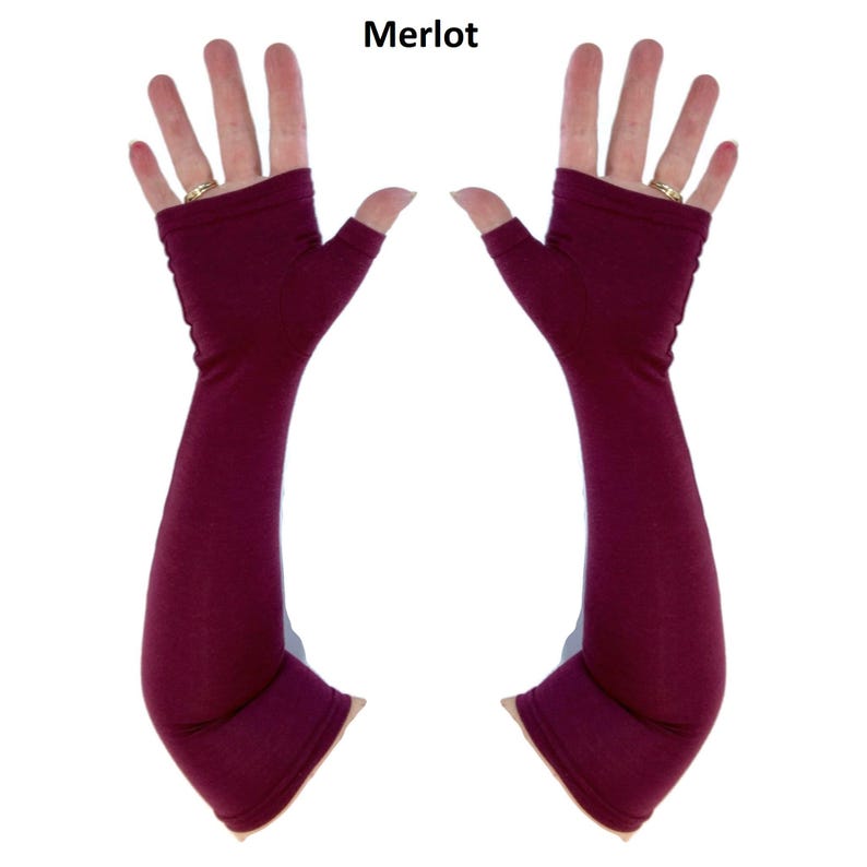 May include: A pair of fingerless arm warmers in a deep merlot colour. These long, solid-coloured sleeves extend from the knuckles to the forearm, featuring an opening for the thumb and a smooth, fitted fabric construction with the text Merlot above.