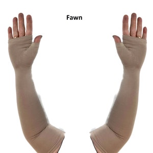 May include: A pair of fawn-coloured, long, fingerless arm sleeves made of a smooth, solid-coloured fabric. The sleeves extend from the knuckles to above the elbow, featuring a dedicated opening for the thumb and a hemmed edge at the top and bottom.