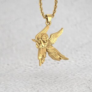 Close up of silver angel charm pendant showing wings and detailed figure carving