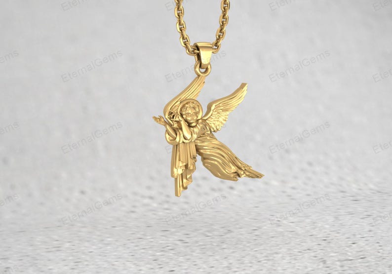 Close up of silver angel charm pendant showing wings and detailed figure carving
