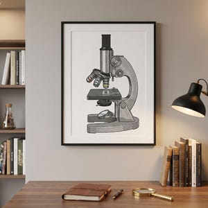 May include: A framed wall art print featuring a detailed black and white illustration of a scientific microscope. The drawing depicts the instrument with a central tube, multiple objective lenses, a stage, and a base, presented in a clean, centered composition.