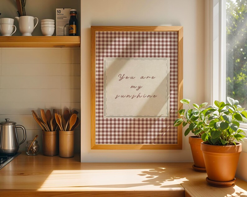 May include: A white ceramic mug with a black handle and the text "But First, Coffee" in a bold, black font. The mug is set against a blurred background, suggesting a cozy setting. The mug appears to be approximately 4 inches tall.