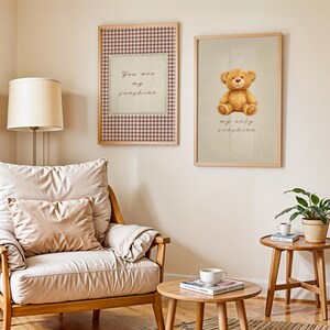 May include: Two framed prints hang on a wall. One features a teddy bear illustration with the text "my only sunshine." The other print has a gingham border and the text "You are my sunshine."