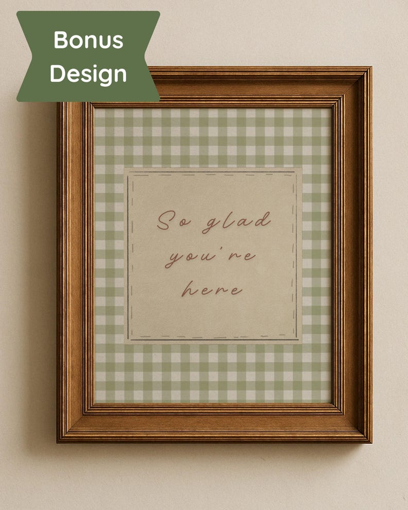 May include: A framed print with a brown wooden frame. The print features a green and white gingham pattern background. A central square has the text "So glad you're here" in a handwritten style font. A green banner in the upper left corner says "Bonus Design".