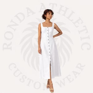 May include: A white midi dress with a square neckline and button-down front. The dress has a fitted bodice and a slightly flared skirt. The model is wearing beige sandals. The dress is made of a lightweight fabric.