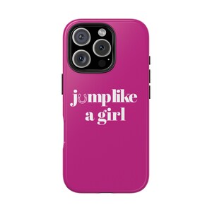 May include: A magenta phone case with a triple-lens camera cutout. The case features the text "jumplike a girl" in white, with a horseshoe graphic above the word "jump". The case is designed for a smartphone.