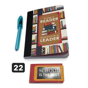 May include: A notebook with a bookshelf graphic and the text Today a READER Tomorrow a LEADER, a blue pen, and a small rectangular card with the text SCHOOL IS THE BEST and the number 22 in a black box, all displayed on a plain white background.