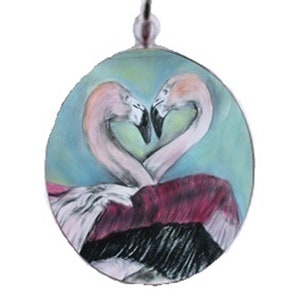 May include: A silver charm with a round glass cabochon featuring a painted image of two pink flamingos forming a heart shape against a blue and green background.