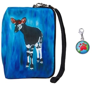 May include: A blue zippered pouch with a black strap and a white and black okapi illustration. A silver charm with a red paw print on a blue globe is attached to the strap.