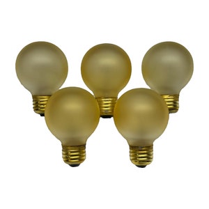 May include: Five round, frosted light bulbs with gold-colored bases. The bulbs have a soft, yellow-gold hue and are arranged against a white background. The bulbs are a classic globe shape.