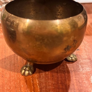 Small brass footed pot