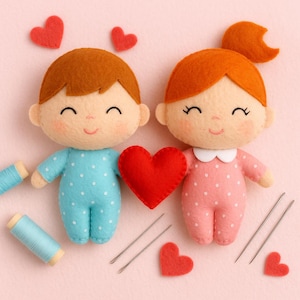 May include: Two handmade felt dolls, a boy in blue and a girl in pink, each with rosy cheeks and smiling faces. They hold a red heart. Scattered around are felt hearts, sewing needles, and spools of blue thread. A charming, handcrafted Valentine's Day theme.
