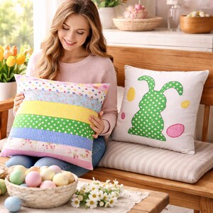 May include: A woman holding a decorative pillow with horizontal stripes of various patterns and colors. Another pillow features a green polka-dot bunny design with Easter eggs. The pillows are on a wooden bench, suggesting a spring or Easter theme.