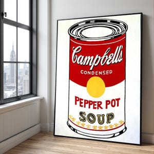 May include: A framed pop art print of a Campbell's Pepper Pot Soup can. The can is red with white text that reads "Campbell's Condensed" and "Pepper Pot Soup." A yellow circle is in the center of the can.