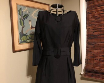 Late 1940s black dress with large button and tab