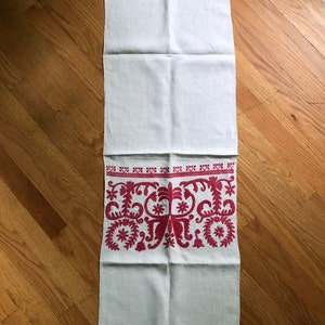 Red-on-white embroidered linen panel