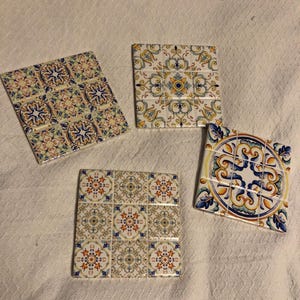 Four assorted Spanish tile trivets