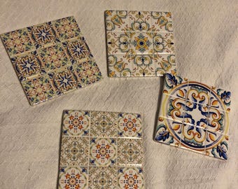 Four assorted Spanish tile trivets