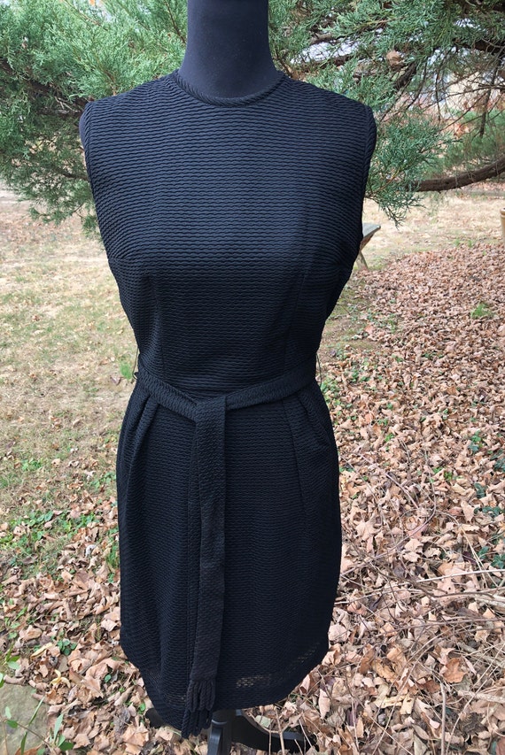 Late 1950s textured fitted black dress with sash