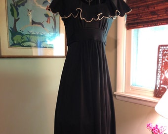 1960s black empire waist dress with scalloped flounce neckline