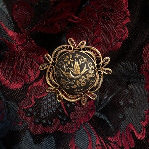 Spanish damascene bird and flower filigree edged brooch