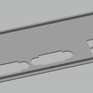 May include: A gray computer back panel with various cut-out shapes for ports and connectors. The rectangular panel has a raised border and includes openings for USB ports, audio jacks, and other components. The design is simple and functional.