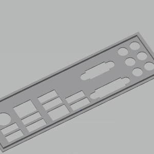 May include: A gray computer component back panel with various rectangular and circular cutouts. The panel has a rectangular shape with a raised border and is angled slightly. The background is a solid gray color.