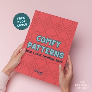 May include: A red coloring book titled "Comfy Patterns" with a pattern of hearts and flowers. The book is held by hands and has the text "Bold & Easy Coloring Book". A teal sticker says "Free Book Cover".