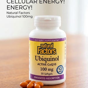 May include: A white bottle of Natural Factors Ubiquinol 100mg dietary supplement with a yellow and purple label. The bottle is next to a small pile of orange softgels. Text on the bottle reads "Boost Your Cellular Energy!"