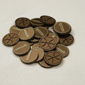 A pile of brown, circular game coins worth one coin. The coins have a raised "1" on the front and a submerged symbol on the back. These premium board game coins replace the standard card board coins.