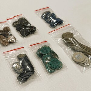 Generic Board Game Coins for sale. Each coin varies in value, size, color and symbol on the coin. Each set of 25 coins is sold in its own zip bag for easy storage and organization.