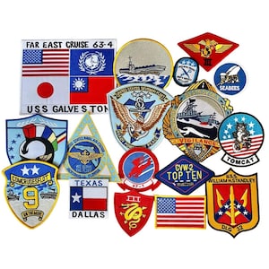 May include: A collection of embroidered patches featuring various military and naval emblems. The patches display flags, ships, eagles, and text such as "USS Galveston," "Texas," and "Tomcat." The patches are in various shapes and sizes, with a mix of colors.