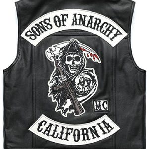 May include: Black leather vest with a large patch featuring a skull with a scythe and rifle, the words "SONS OF ANARCHY" and "CALIFORNIA" in white lettering. The vest has a button closure.